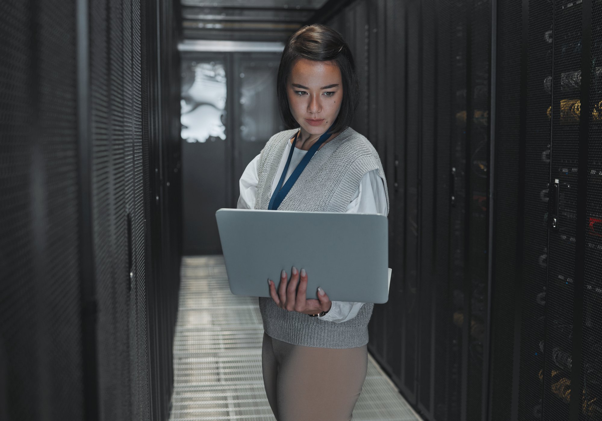woman-with-laptop-server-room-and-it-engineer-an-2023-03-08-19-28-26-utc